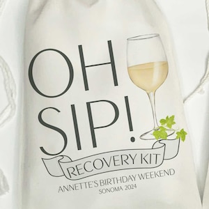 May include: White canvas bag with the text "Oh Sip! Recovery Kit" and a drawing of a glass of white wine. The text below the drawing says "Annette's Birthday Weekend Sonoma 2024".