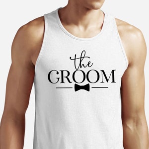 May include: White tank top with the text "the GROOM" in black lettering with a black bow tie underneath.