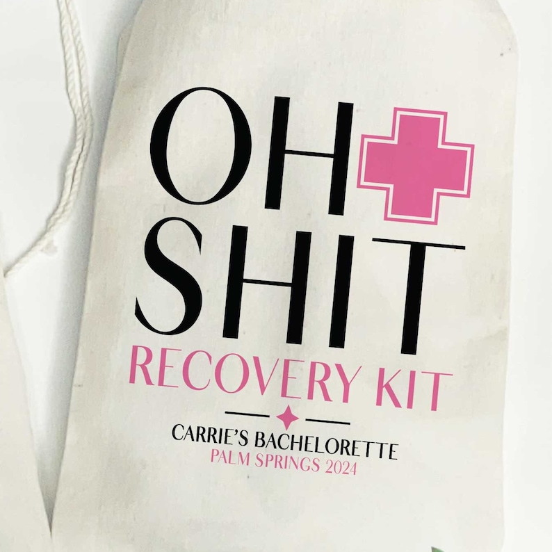 May include: A white fabric drawstring bag featuring black and pink text that reads OH SHIT RECOVERY KIT, with a pink medical cross symbol. Below, it says CARRIE'S BACHELORETTE PALM SPRINGS 2024 in black and pink lettering with a small four-pointed star.