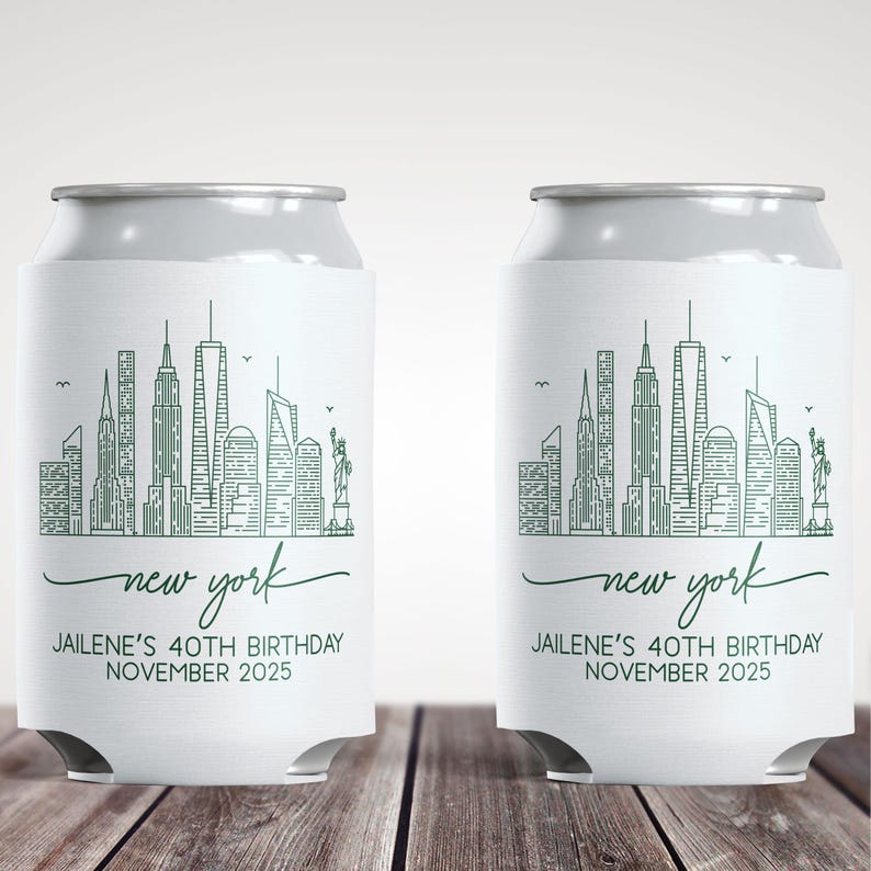May include: Two white can coolers with a green New York City skyline design. The text "new york" is written in cursive, with the text "JAILENE'S 40TH BIRTHDAY NOVEMBER 2025" below it.