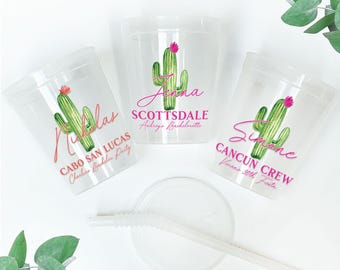 May include: Clear plastic cups with a green cactus design and pink text. The cups are personalized with names and locations such as "Jenna Scottsdale Audrey's Bachelorette" and "Nicholas Cabo San Lucas Charlie's Bachelorette Party."