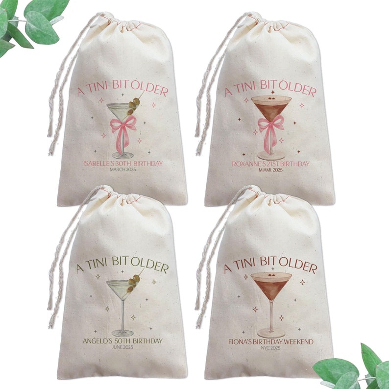 May include: Four white cotton drawstring bags with a pink and gold design of a martini glass with olives and a pink ribbon. Each bag has a personalised message with a name, age, and date. The text reads "A Tini Bit Older".