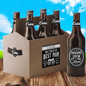 May include: A six-pack of brown beer bottles with black and white labels. The labels say "Calvin" and "Groom's Crew Brew 2021". One label says "Calvin Will You Be My Best Man".