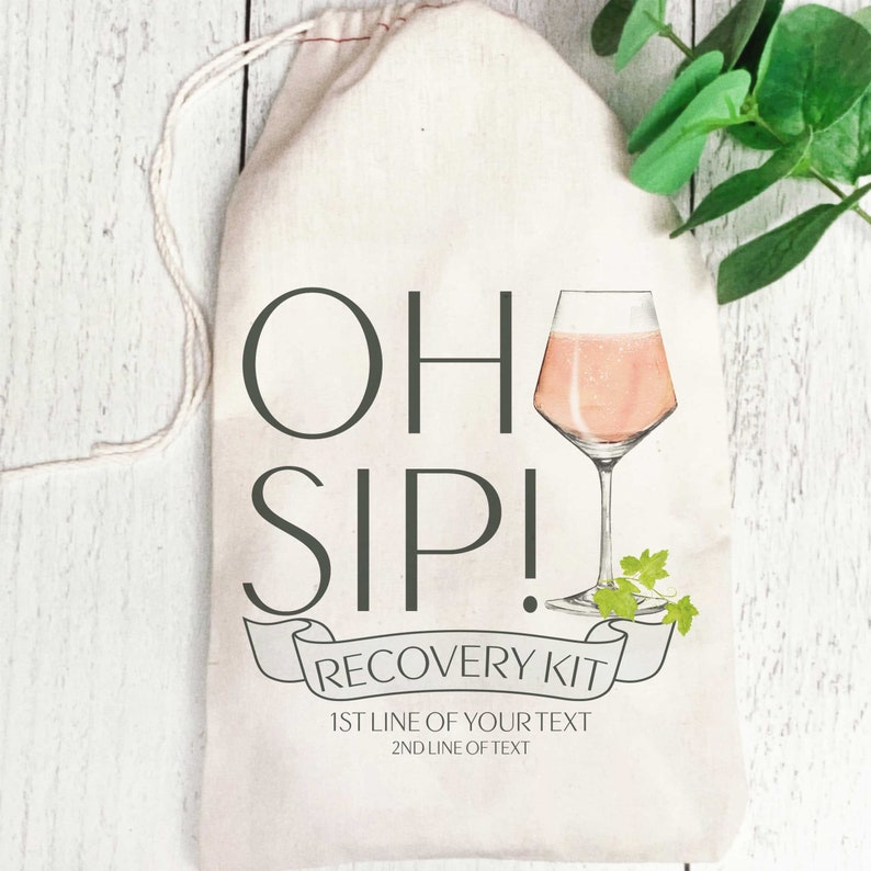 May include: White canvas bag with a drawstring closure. The bag has a graphic of a glass of pink wine with the text "Oh Sip! Recovery Kit" and "1st line of your text 2nd line of text".