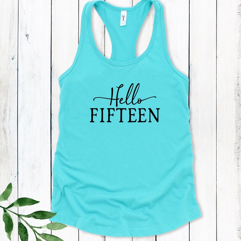 May include: A turquoise tank top with the text "Hello FIFTEEN" in black.