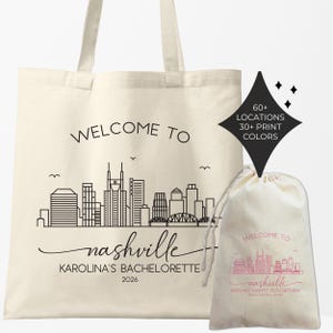 May include: Off-white tote bag and drawstring bag with a black skyline graphic and the words "WELCOME TO nashville". The tote bag also says "KAROLINA'S BACHELORETTE 2026". A black diamond shape indicates "60+ LOCATIONS 30+ PRINT COLORS".