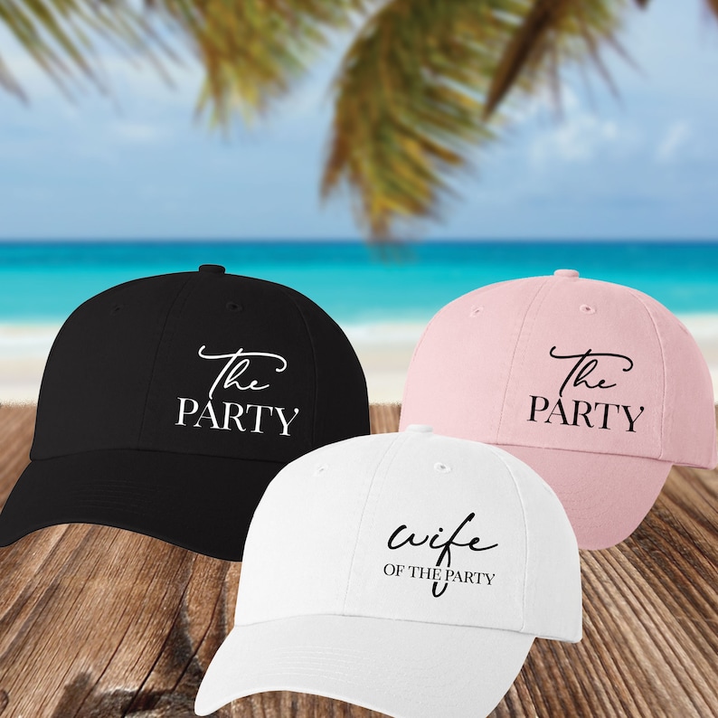 May include: Three baseball caps with different text. The first cap is black with white text that says "The Party". The second cap is pink with white text that says "The Party". The third cap is white with black text that says "Wife of the Party".