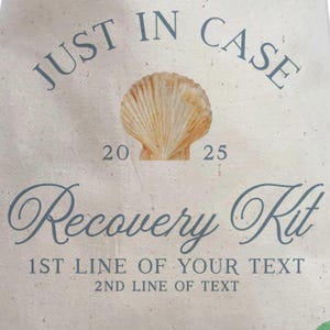 May include: A beige canvas bag with the words "JUST IN CASE" in blue script at the top. A seashell graphic is centered above the text "Recovery Kit". The text "20 25" is above the seashell. The bottom has space for custom text.