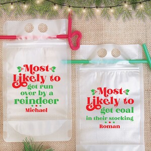 May include: Two clear plastic drink pouches with red and green text. The text on the left pouch reads "Most Likely to get run over by a reindeer Michael". The text on the right pouch reads "Most Likely to get coal in their stocking Roman".