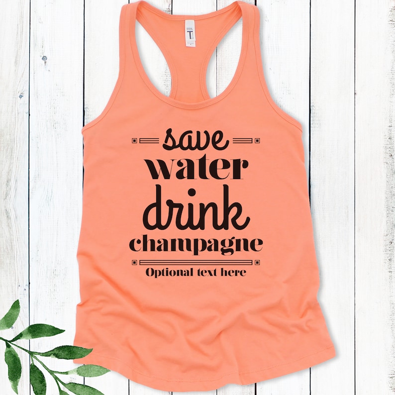 May include: A peach-colored tank top with the text "save water drink champagne" in black. The text is framed with a black border. The text "Optional text here" is also included in black.