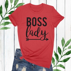 May include: Red t-shirt with black text that says "BOSS lady" with a black arrow pointing to the right.
