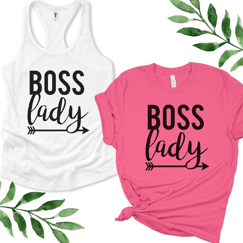 May include: Two shirts with the text "Boss lady" and an arrow pointing to the right. One shirt is white and the other is pink.