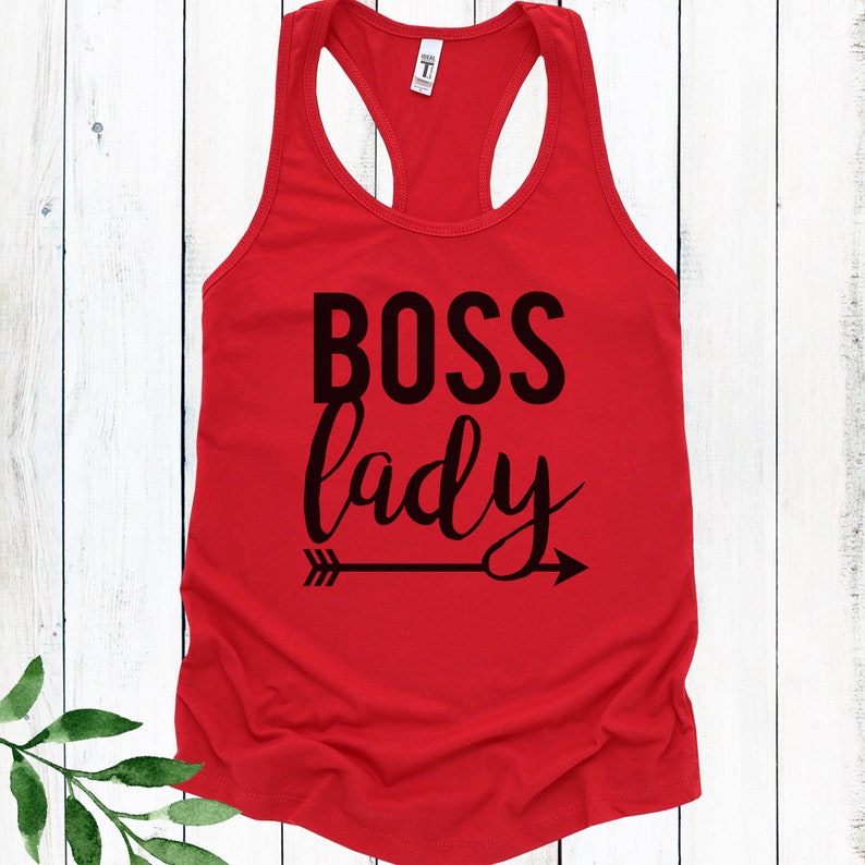May include: Red racerback tank top with black text that reads "BOSS lady" and a black arrow pointing to the right.