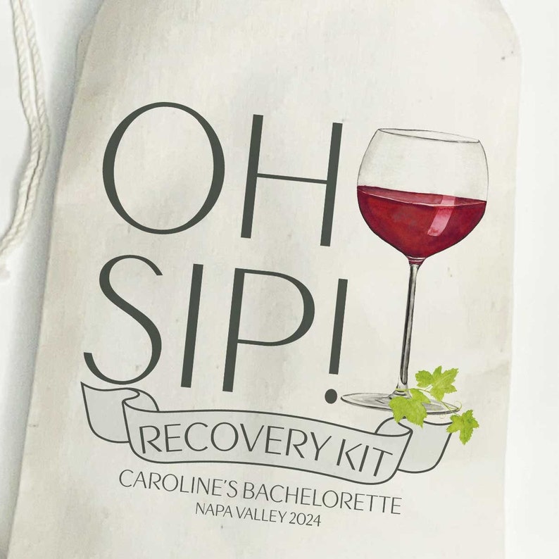May include: White canvas bag with a drawstring closure. The bag has a green and black graphic that says "Oh Sip! Recovery Kit" with a red wine glass illustration. The text below the graphic says "Caroline's Bachelorette Napa Valley 2024".