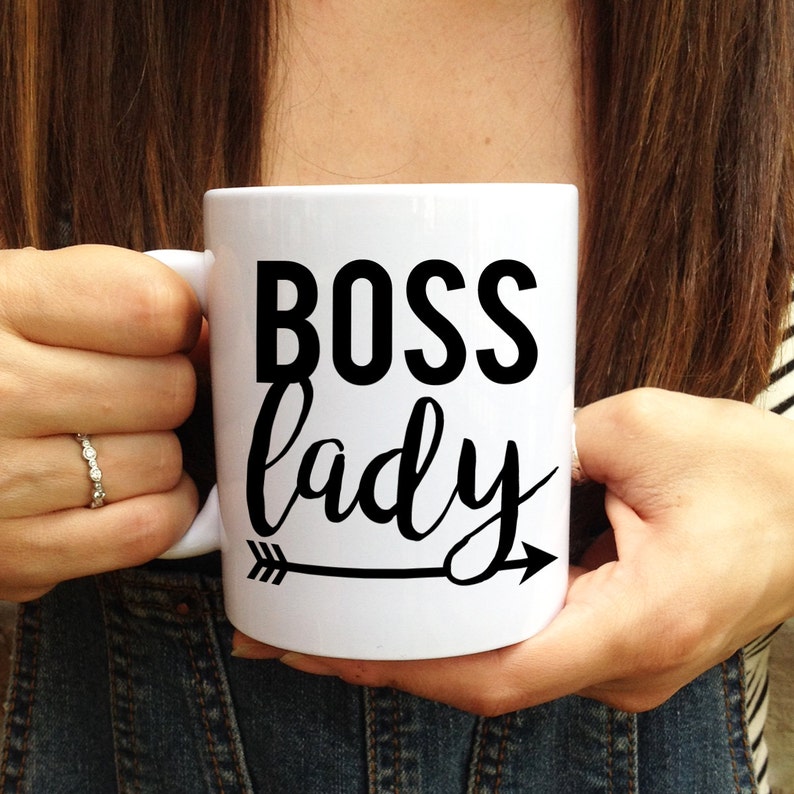 May include: White ceramic mug with a black arrow and the text "BOSS lady" in black lettering.