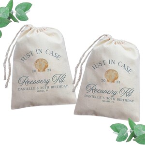 May include: Two off-white drawstring bags with the text "JUST IN CASE" above a seashell graphic and the text "Recovery Kit" below. The bags also include the text "DANIELLE'S 30TH BIRTHDAY MIAMI, FL."