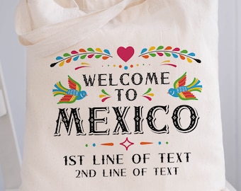 Puede incluir: Una bolsa de lona blanca con un diseño mexicano colorido. El texto dice "Bienvenido a México" con un corazón y pájaros. La bolsa también tiene el texto "1ra línea de texto" y "2da línea de texto".
