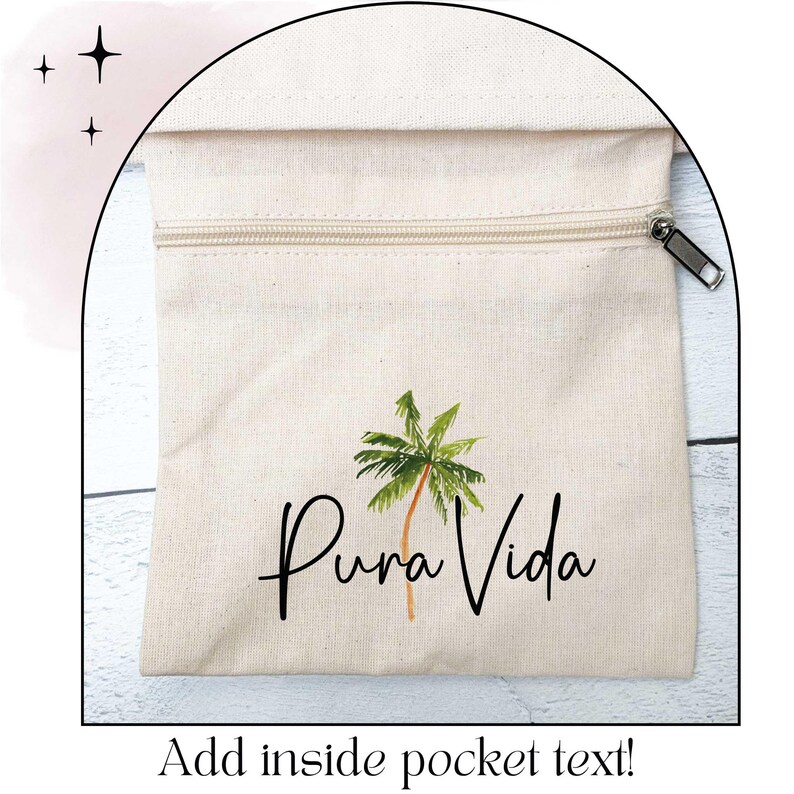 May include: A beige canvas bag with a zipper closure and a palm tree illustration. The words "Pura Vida" are written in a script font below the palm tree. The text "Add inside pocket text!" is at the bottom.