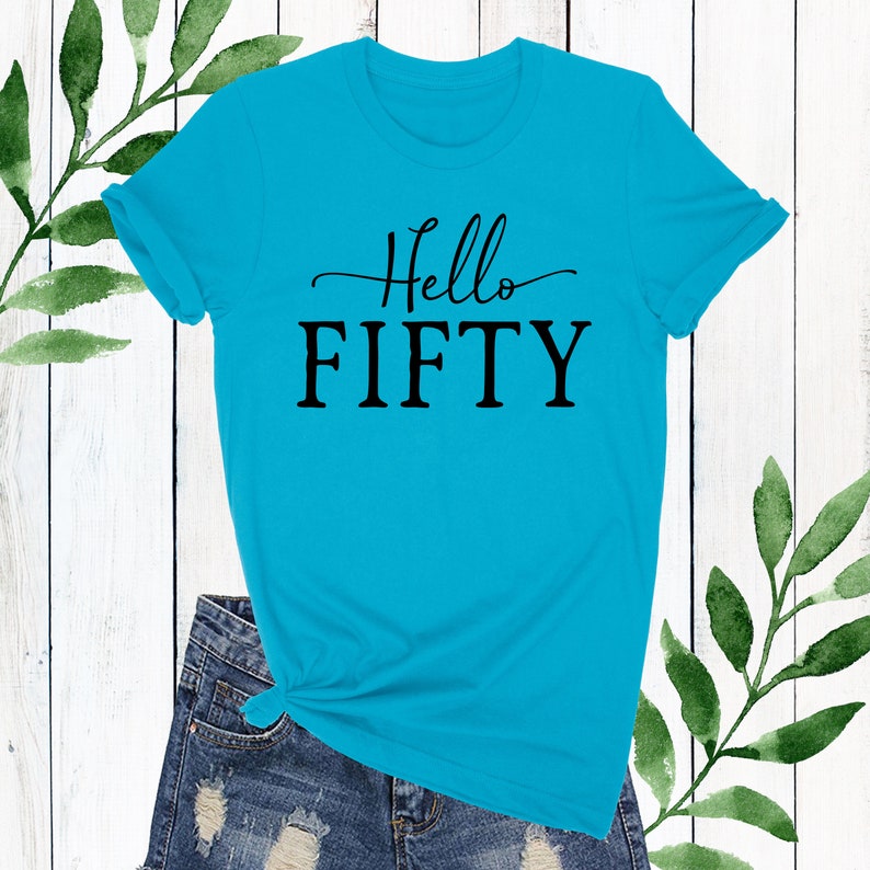 May include: A turquoise blue t-shirt with the text "Hello Fifty" in black lettering.
