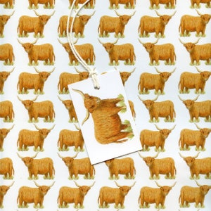 May include: White wrapping paper with a repeating pattern of brown Highland cows. A white tag with a drawing of a Highland cow is attached with a string. The tag is angled, partially obscuring the pattern.