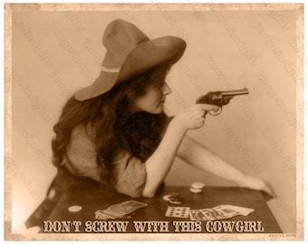 May include: A sepia-toned vintage photograph of a woman wearing a wide-brimmed hat and holding a revolver. She is sitting at a table with playing cards and chips. The text "DON'T SCREW WITH THIS COWGIRL" is printed below the image.