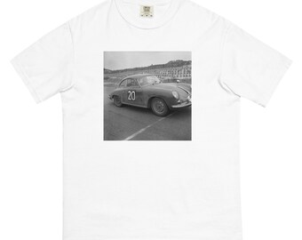 May include: A black and white photograph of a vintage Porsche race car with the number 20 on the side. The car is on a race track.
