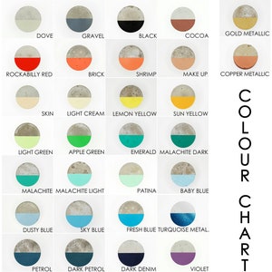 May include: Colour chart displaying 25 different colour options for concrete. The colours are arranged in rows and columns, with each colour represented by a half-circle painted on a concrete disc. The colours include natural matt, white, pebble, steel, silver metallic, dove, gravel, black, cocoa, gold metallic, rockabilly red, brick, shrimp, make up, copper metallic, skin, light cream, lemon yellow, sun yellow, light green, apple green, emerald, malachite dark, malachite, malachite light, patina, baby blue, dusty blue, sky blue, fresh blue, turquoise metal, petrol, dark petrol, dark denim, violet, lilac, amaranth, gleaming pink, and iced raspberry.