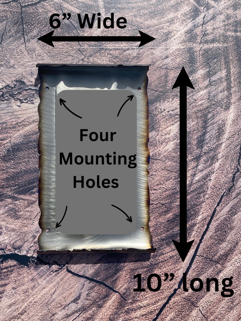 May include: A metal sign with a rustic, burnt finish. It measures 10 inches long and 6 inches wide. The sign has four mounting holes and the text "Four Mounting Holes" is printed on the sign.