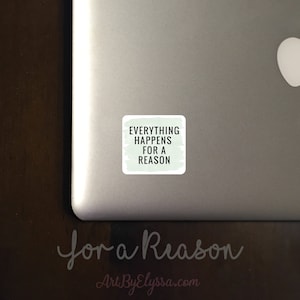 May include: A white sticker with a green background and black text that reads "Everything Happens For A Reason". The sticker is on a silver laptop.