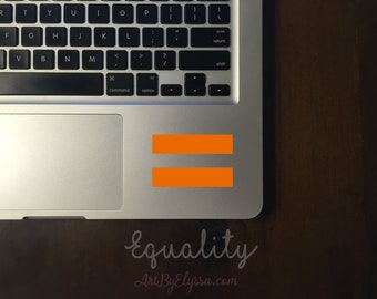 May include: A silver laptop with an orange equal sign sticker on the trackpad. The text "Equality" and "ArtByElyssa.com" are written below the laptop.