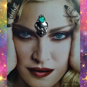 May include: A silver-toned metal pendant featuring a central oval turquoise-coloured stone, positioned on the forehead of a printed portrait. The text FairyLovejewels etsy and Always purchase where you see my name on photo are visible on the image.