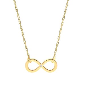 May include: A gold-colored necklace featuring an infinity symbol pendant with a small, clear gemstone at its center. The pendant is suspended from a delicate chain. The necklace is displayed against a white background.