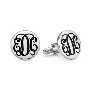 May include: A pair of round, silver-toned metal cufflinks featuring a polished finish. Each cufflink is engraved with a black, ornate, interlocking three-letter monogram design in a script font, centered on the circular face of the accessory.