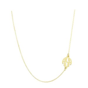 May include: A gold chain necklace with a gold monogram pendant. The pendant is a circle with the letters "ASA" inside.