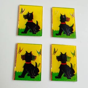 May include: Four rectangular glass tiles featuring a black dog with a red collar, set against a yellow background with green grass and butterflies. The dog is a stylized illustration. The tiles are arranged in a 2x2 grid.