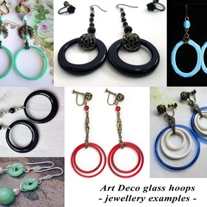 May include: A collection of Art Deco glass hoop earrings in various colours and styles, including black, red, blue, and green. The earrings feature different designs, such as single hoops, double hoops, and triple hoops. The earrings are all made of glass and have a vintage look.