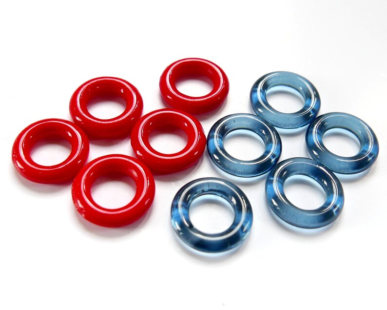 May include: A set of ten glass rings, five red and five blue. The rings are all the same size and shape, and they are arranged in a circle.