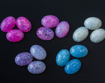 May include: Assortment of oval-shaped cabochons in various shades of pink, blue, and white. The cabochons have a marbled, cloudy appearance.