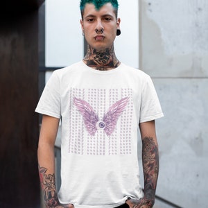 May include: White t-shirt with a pink and purple eye with wings graphic and the text "Funny seeing you here" repeated multiple times.