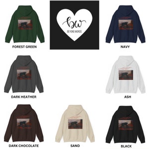 May include: A set of ten hooded sweatshirts in various colors, including forest green, navy, dark heather, ash, dark chocolate, sand, and black. Each sweatshirt features a graphic print on the back of a dog walking on a wooden plank with the text "Beyond Words" in red.