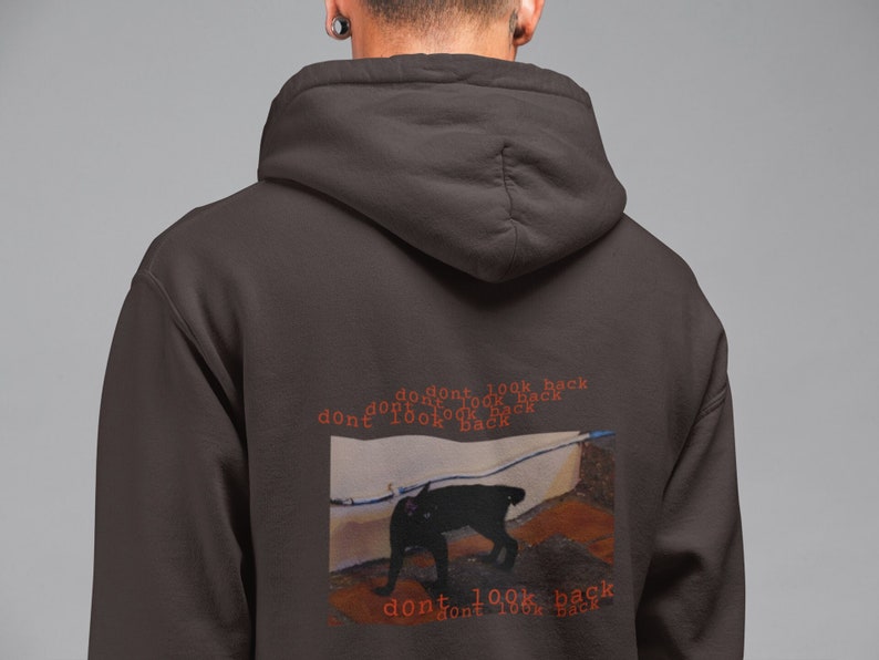 May include: A dark brown hoodie with a black cat graphic and the text "don't look back" repeated multiple times in red.