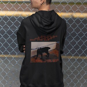 May include: Black hoodie with a graphic of a black cat and the text "dont look back" repeated multiple times.