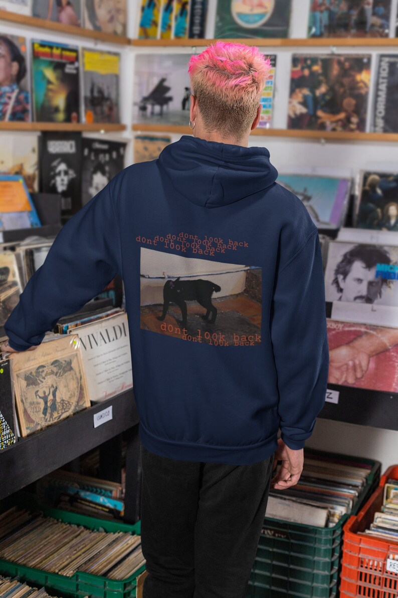 May include: A navy blue hoodie with a black cat graphic and the text "dont look back dont look back dont look back dont look back" on the back.