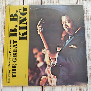 May include: Vintage vinyl record album cover featuring B.B. King. The album is titled "The Great" and is presented by Fairway Records. The cover has a yellow vertical stripe with the album title and artist's name in bold, black text. The image shows B.B. King playing a guitar.