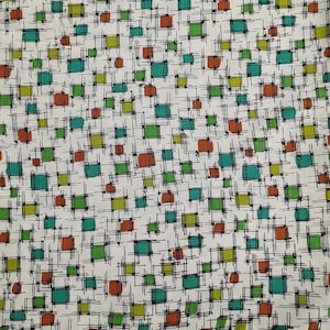 May include: White fabric with a repeating pattern of colorful squares and dots. The squares are in shades of teal, green, and orange, outlined with black lines. The dots are orange. The design has a retro, mid-century modern feel.