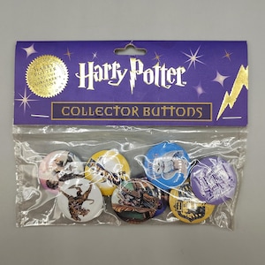 May include: A package of Harry Potter collector buttons. The package is purple with gold text and a gold seal that reads "Harry Potter and the Sorcerer's Stone". The buttons are round and feature various images and the Hogwarts crest.