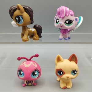 May include: Four colorful collectible animal figurines. A brown horse with a dark brown mane and tail, a pink and purple winged creature, a pink bug-like figure, and a tan dog with brown markings.