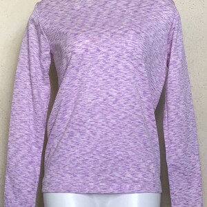 May include: A long-sleeved shirt in a purple and white speckled pattern.