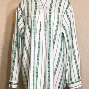 May include: White and green striped long-sleeve shirt with a diamond pattern. The shirt has a button-up front and a mandarin collar.