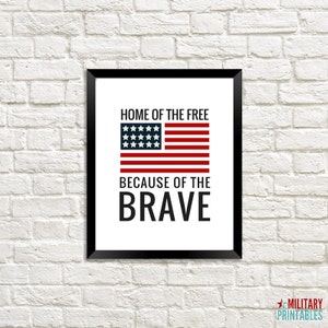 May include: A framed print with a white background and black text that reads "Home of the Free Because of the Brave". A red, white, and blue American flag is centered above the text.